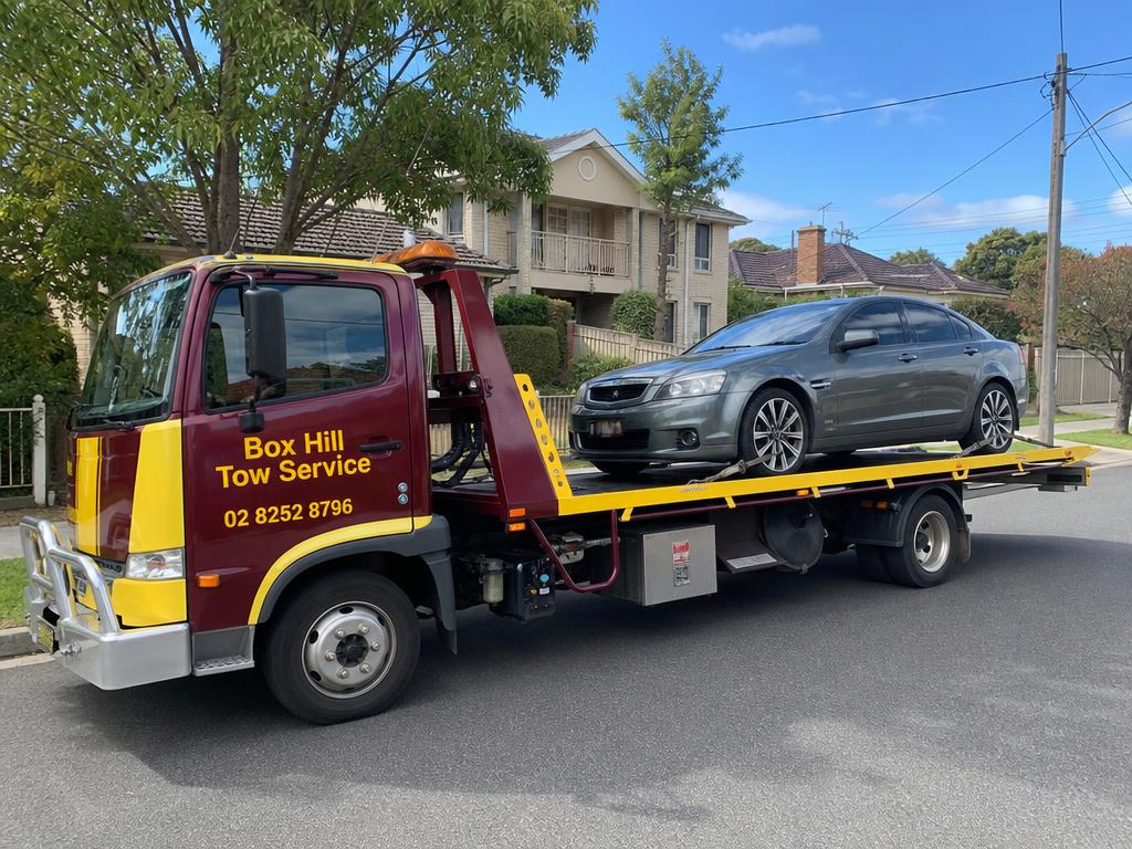 Car loaded on a Box Hill Tow Service flatbed tow truck